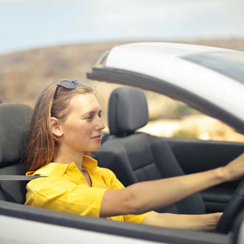 Woman driving a convertible car